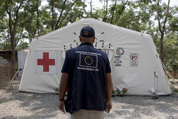 Aid worker in front of field hospital tent