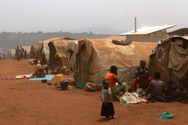 View of tents in a camp with at the forefront a family and child