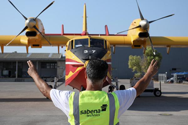 Canadair plane being guided by a man in the front