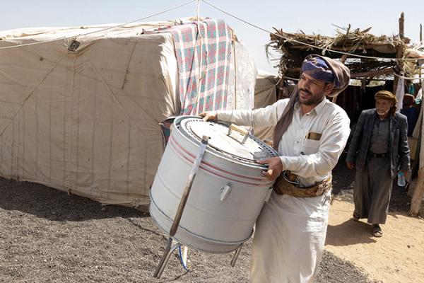 Bashir carrying a bread oven