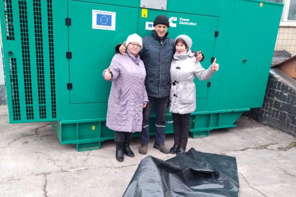 3 people in front of a generator