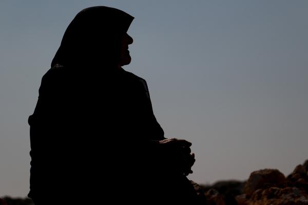 Woman sitting in the evening dawn