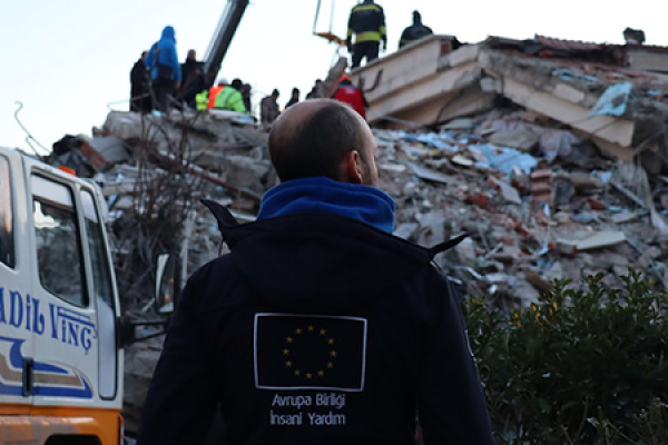 EU civil protection officer standing in front of the rubble caused by the earthquake in Türkiye 
