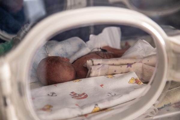 A premature born child in an incubator.