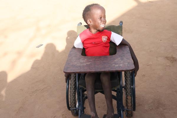 Achok in his wheelchair seen from the front.