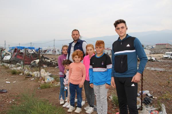 Photo of Hassan's family outside in a field.