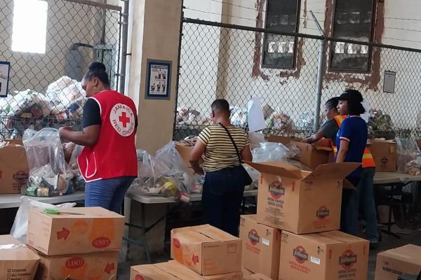 Aid workers filling boxes with emergency goods.